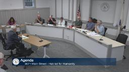 Thumbnail of meeting video shows a wide shot of the entire board in Rm A with one person sitting at the presenter's table. 