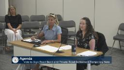 Thumbnail of meeting video shows the presenter's table with two people sitting at it and one person in the audience.