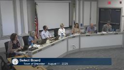 Wide shot of entire board and two staff in meeting room A.