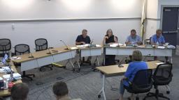 wide shot of four commission memebers at the meeting table in rm b