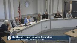 The HHS committee is sitting behind the large meeting table in meeting rm a.
